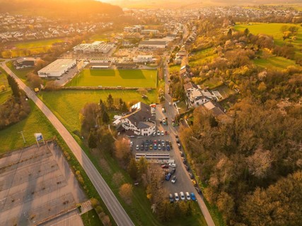 Aerial view of an urban landscape with fields and buildings at dusk, Europäischer Hof, Königsbach,