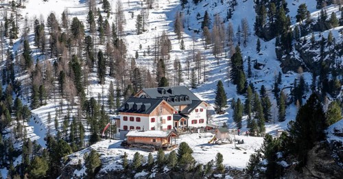 Zufallhütte mountain hut, view of the Martell Valley, snow-covered mountain landscape in winter,