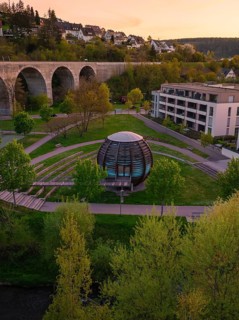 Futuristic building in a park by a viaduct, surrounded by green countryside, Nagold, Calw district,