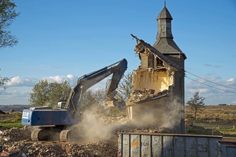 Demolition with an excavator, dismantling, house demolition, demolition of a house, demolition