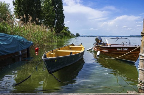 Shoreline landscape and moored boats on the edge of Lake Constance on the island of Reichenau,