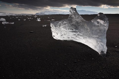 Little icebergs and crushed ice on the black beach at Joekulsarlon glacial lake