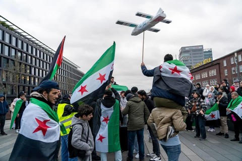 People celebrate the end of the Assad regime after the change of power in Syria at a rally on the