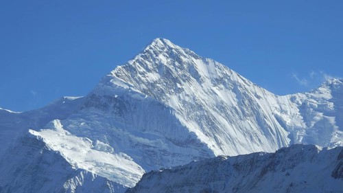 Majestic snow-capped summit of Gangapurna under a bright blue sky, trekking at Annapurna Circuit,