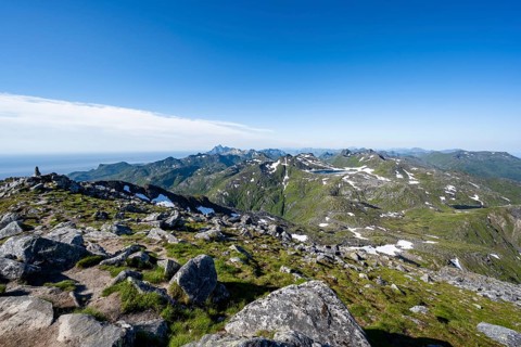 View of mountain peaks, mountaineers at the summit of Rundfjellet, Svolvaer, Nordland, Norway