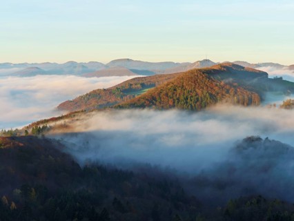 View from the Gisliflue of the Jurassic foothills covered in fog with the water fluh in the morning