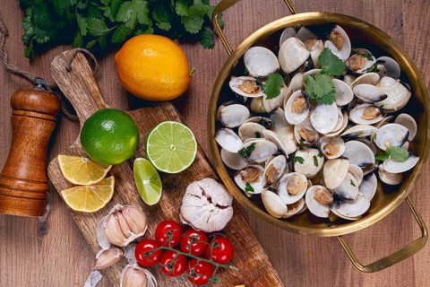 Cooking, vongole clams, in a pan with spices and white wine, top view, no people