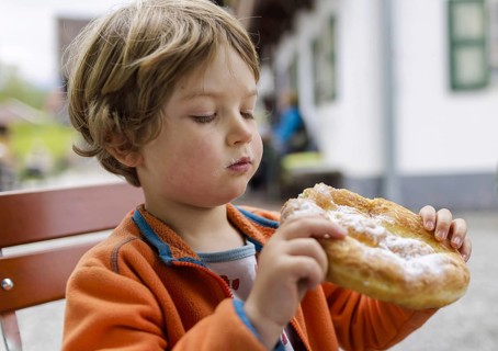 Topic: Child with an undressed man, a traditional Bavarian pastry, Murnau, 19.05.2023