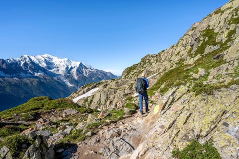 Mountaineers on a hiking trail in front of a mountain panorama, view of mountain peaks Grandes