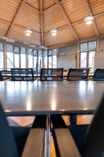 Modern conference room with wooden panels and large windows for a bright and inviting atmosphere,