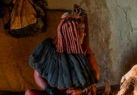 Traditional Himba woman shows her traditional hairstyle, near Opuwo, Kaokoveld, Kunene, Namibia