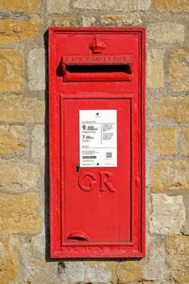 Old red letterbox in a wall, Snowshill, The Cotswolds, England, Great Britain