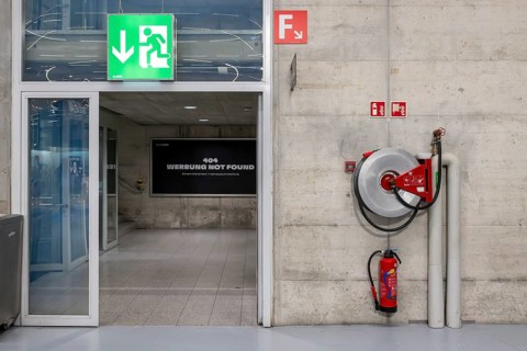 Symbolic photo of emergency exit, fire extinguisher and water hose, Bern, Switzerland