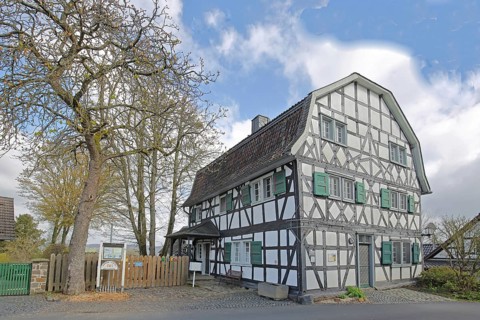 Grey town house rune house built in 1642 with wine museum, half-timbered house with mansard roof