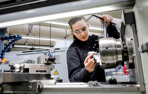 Remscheid, North Rhine-Westphalia, Germany - Trainee woman in metalworking, here at a machine tool,
