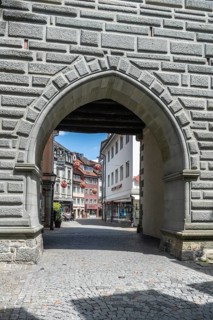 View through the Schnetztor, historic city gate to the pedestrian zone in the old town of