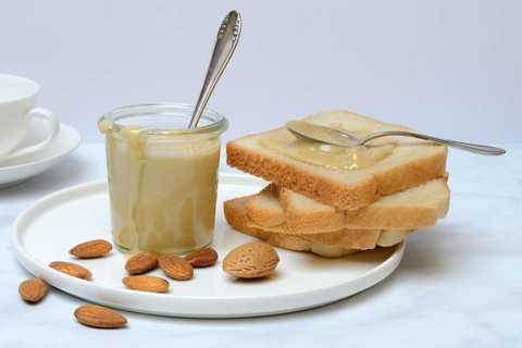 Almond cream in a jar and toast
