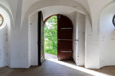 View through an open door into the greenery, Pavilion at Michaelisberg, Bamberg, Bavaria, Germany