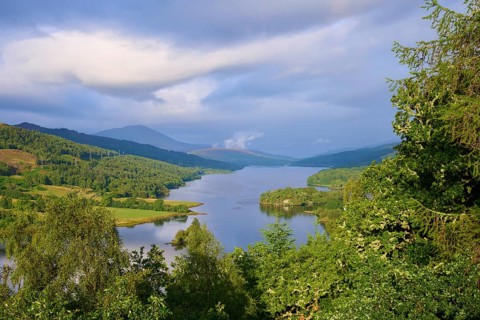 Lake surrounded by green hills under a sky with moving clouds, Queens View, Fincastle, Pitlochry,