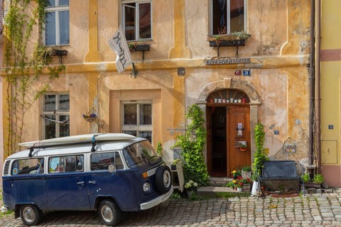 One van Volkswagen Bulli T2 standing in front of the Lazy River Hostel in Loket, Czech Republic