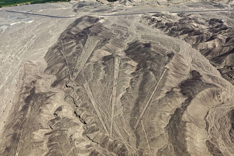 Dry desert with distinctive lines and geometric shapes on the mountain flanks, the geoglyphs and