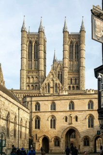 Towers of cathedral church rise above the medieval Exchequer Gate, Lincoln, Lincolnshire, England,