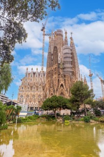 Basilica of the Sagrada Familia in Barcelona by the lake without people, Spain
