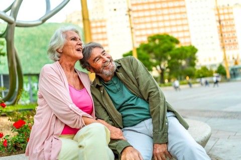 Horizontal photo with copy space of a senior couple sitting together relaxed enjoying day at city