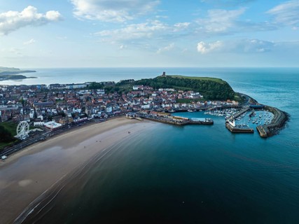 Scarborough Lighthouse and Harbour from a drone, Vincent Pier, Scarborough, North Yorkshire,