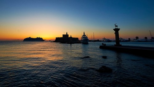 Quiet harbour with boats and a historic fortress, sunrise, dawn, Fort of Saint Nikolaos, Mandraki