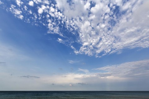 Sunbeams behind clouds at the sea, cloudy sky in summer, weather forecast, Kent, England, Great
