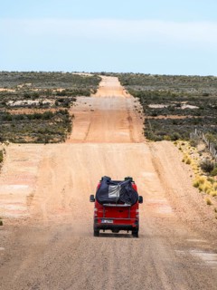 4x4 campervan drives along the road near Estancia la Maciega, Chubut, Argentina