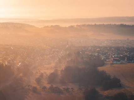 Picturesque village in rolling hills in early morning fog, Gechingen, Calw district, Germany