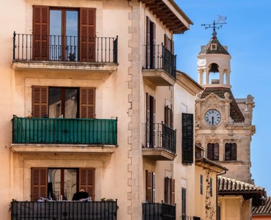 Residential buildings and the tower of the town hall, Ajuntament d'Alcúdia, Majorca, Spain
