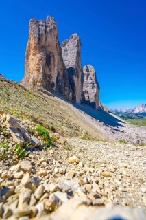 Rocky hiking trail leading to the majestic tre cime di lavaredo peaks in the dolomites, italy, on a