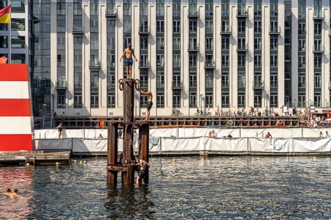 Young people diving into the harbour, Fisketorvet harbour swimming pool in Copenhagen, Denmark