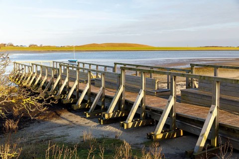 Wooden jetty on the mudflats on the south beach, in the background the south beach polder dyke,