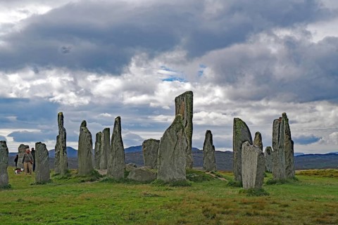An ancient stone circle in front of gloomy clouds, a mysterious atmosphere, Standing Stones of