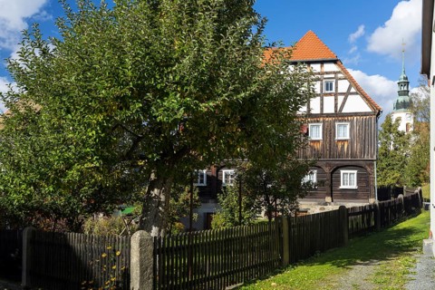 Half-timbered house, in the background the baroque church of Obercunnersdorf, Oberlausitzer
