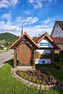Tourist sign, wine village, holiday resort, tourist region Achertal, hilly landscape with forest,