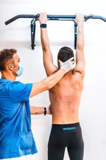Physiotherapist with the hand on the neck of a patient in a dominated. Physiotherapy with