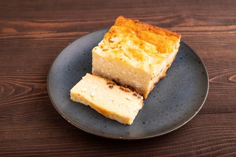 ?ottage cheese ?asserole, Curd cake, with dried apricots and raisins on brown wooden background,