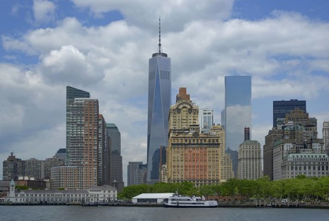 Manhattan's skyline showing notable landmarks like the towering One World Trade Center, flanked by