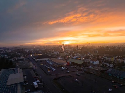 Cityscape at sunset with glowing sky and dark silhouettes of buildings, Meßkirch, Sigmaringen