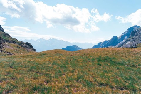 Captivating landscape of the Ibones de Anayet in Huesca, Spain, showcasing lush grasslands against