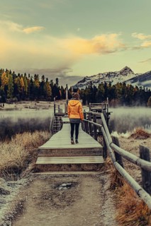 Young woman at Lake Staz near Sankt Moritz in the Engadine in Switzerland. Morning atmosphere with