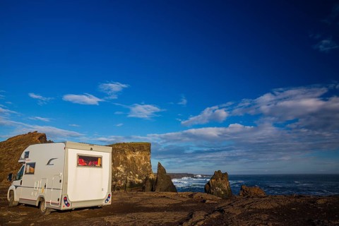 Motorhome parking on the shoreline, south of Sandvik with crashing waves. Rough nature