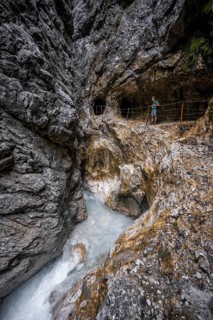 Hammersbach mountain stream in a canyon, mountaineer on a hiking trail in a gorge, Höllentalklamm,