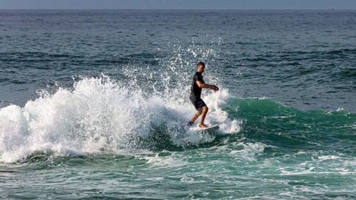 Surfer shows off his skills on impressive waves, surfers in the Indian Ocean at Galle in Sri Lanka