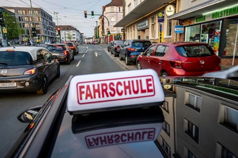 Symbolic picture driving school, driving in the city center, urban traffic